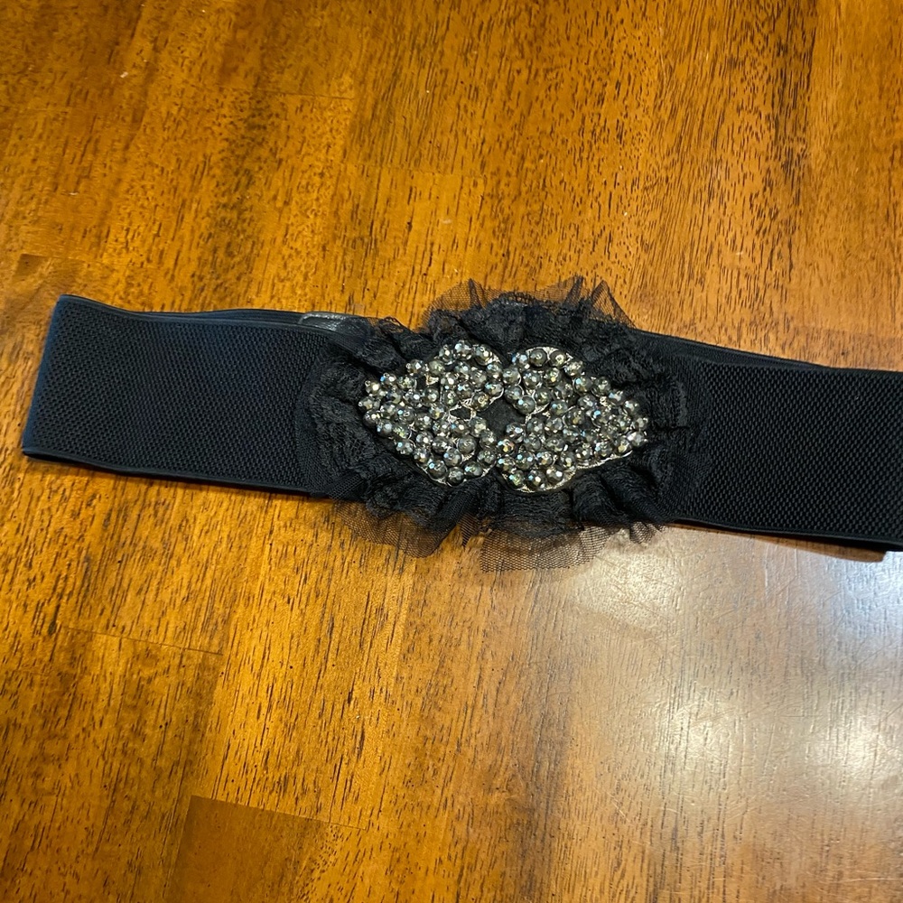 black belt with lace and sequins. Stretchy Size S/M. Snap closure.